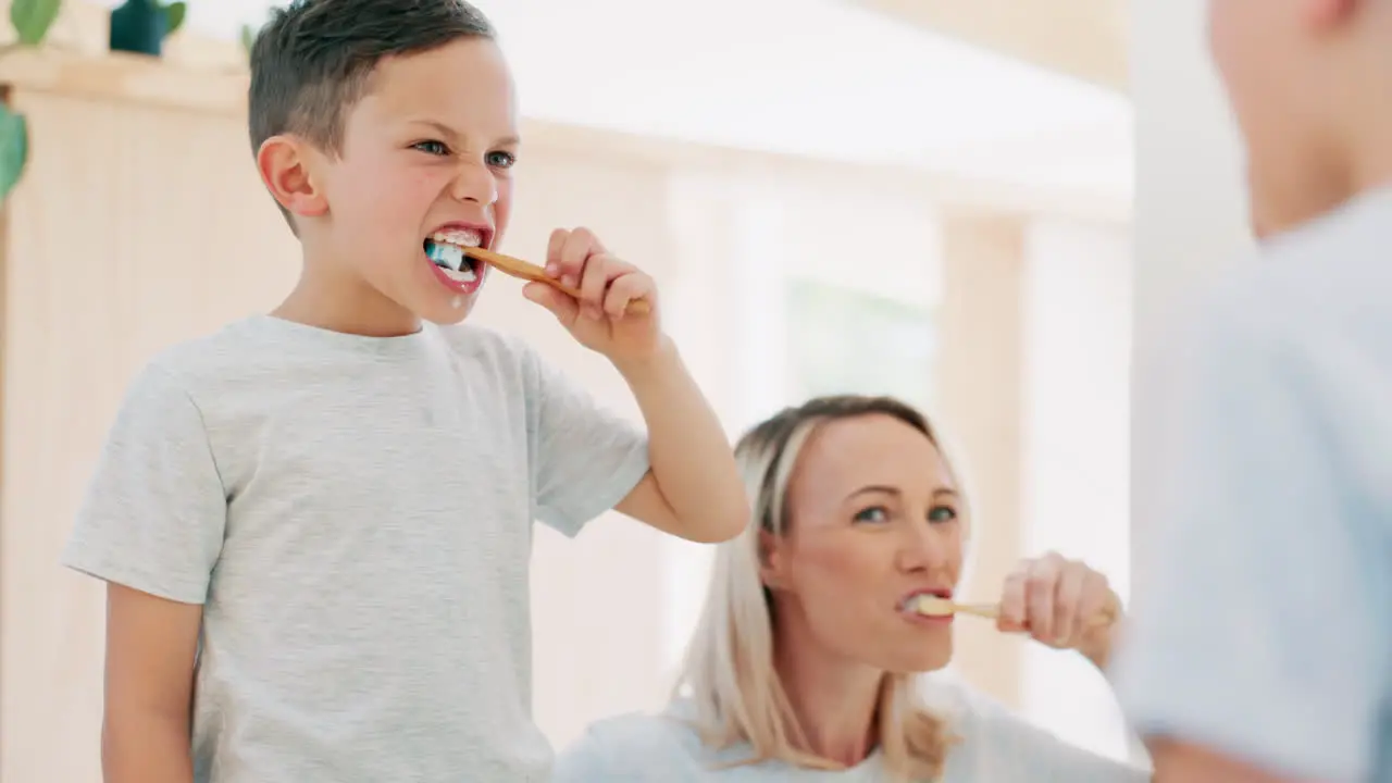 Morning bathroom and mom brushing teeth