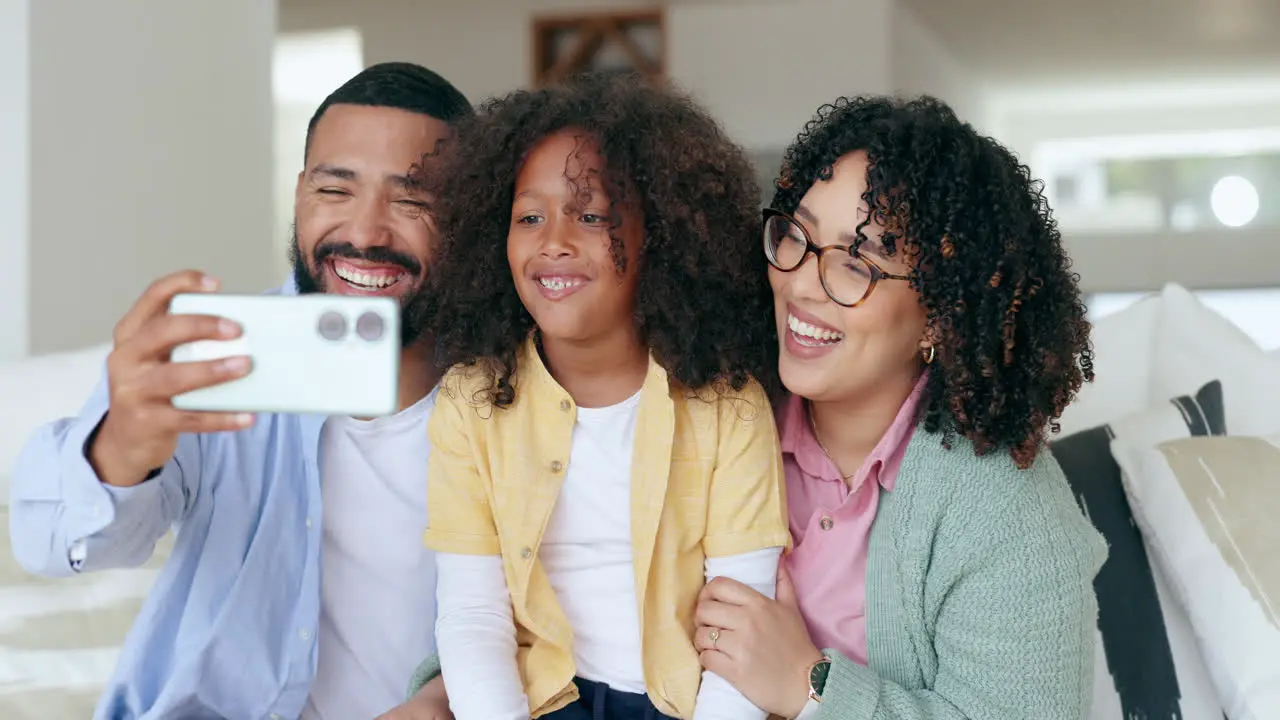 Mother father and child selfie on sofa for home