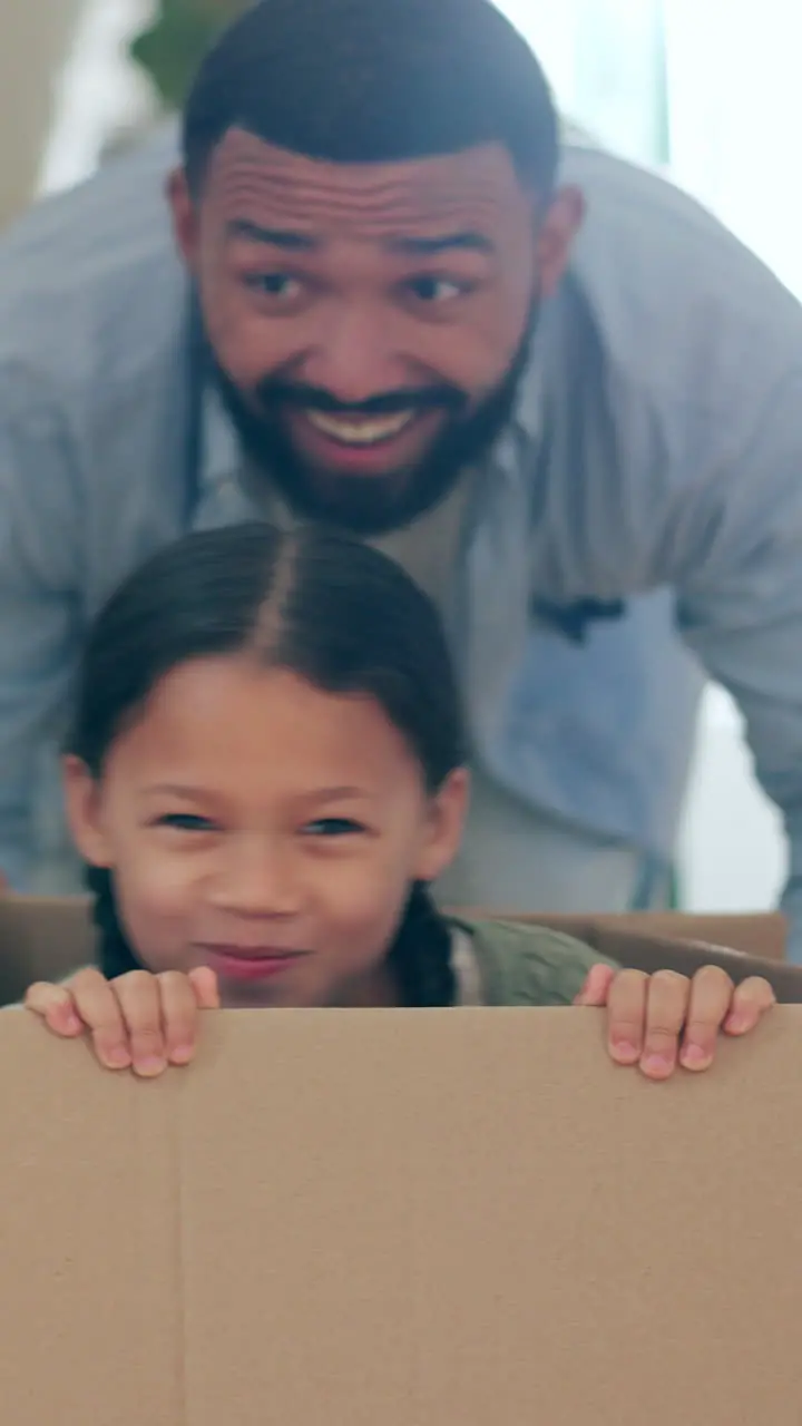 Happy family moving in new home with box in real