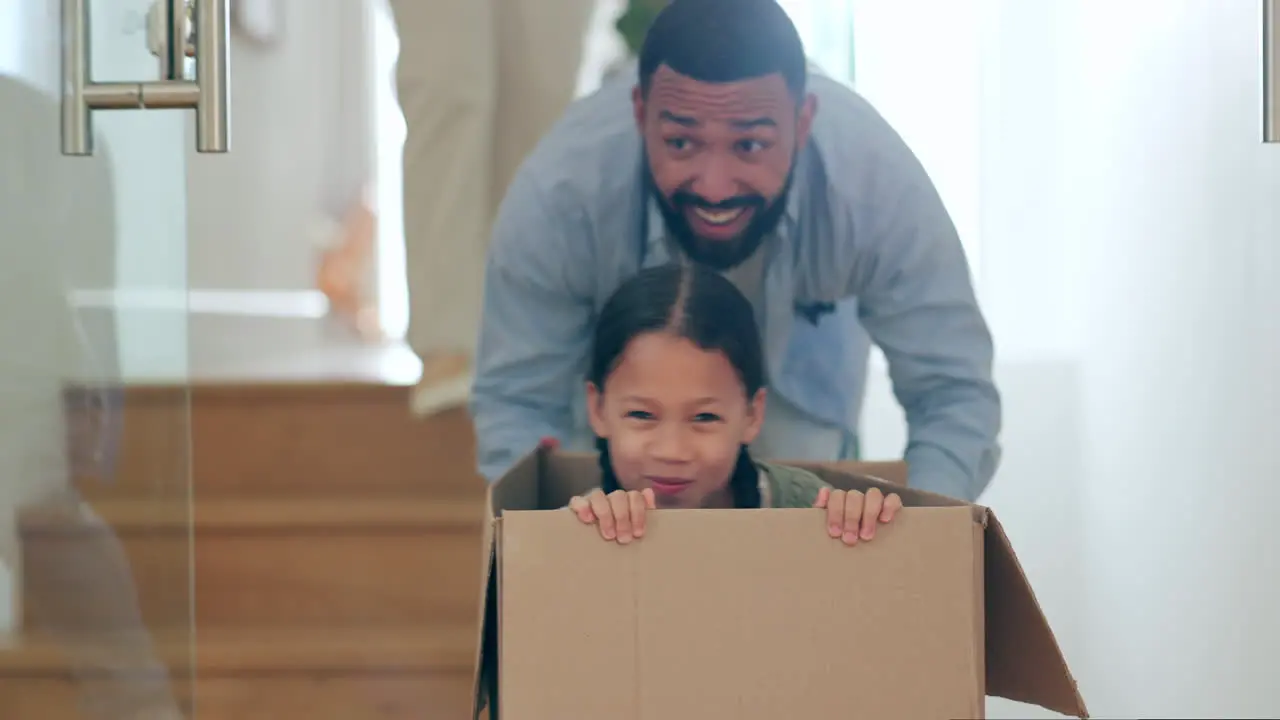 Happy family moving in new home playing with box