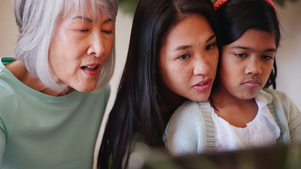 Face tablet and an asian family in the living