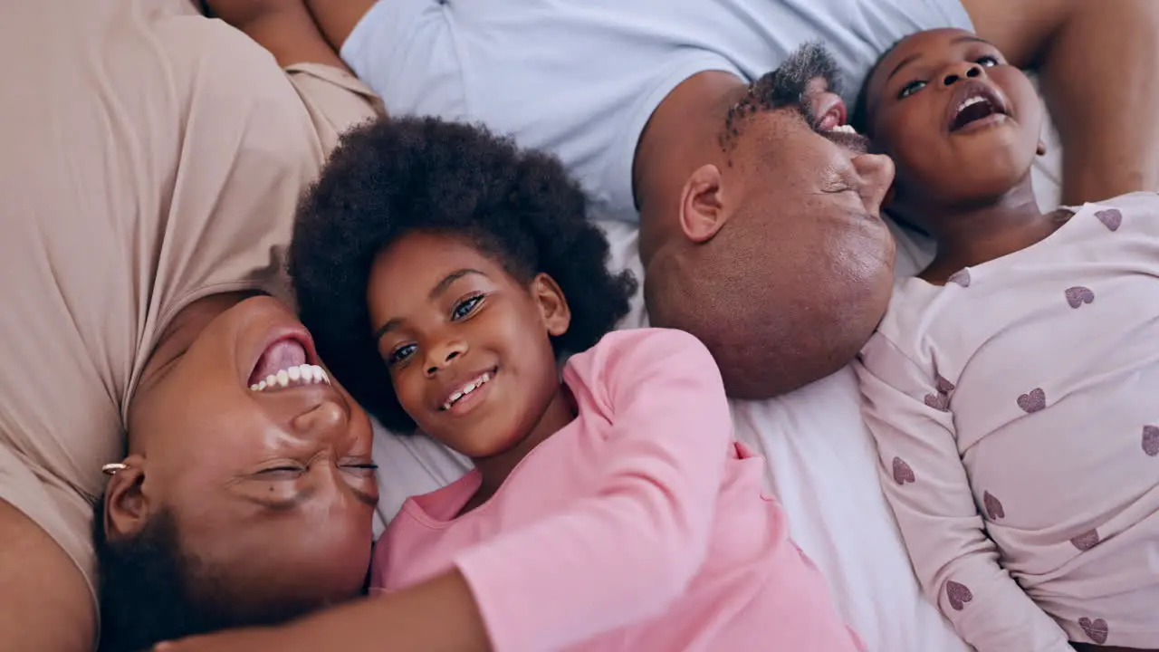 Smile relaxing and black family having fun in bed