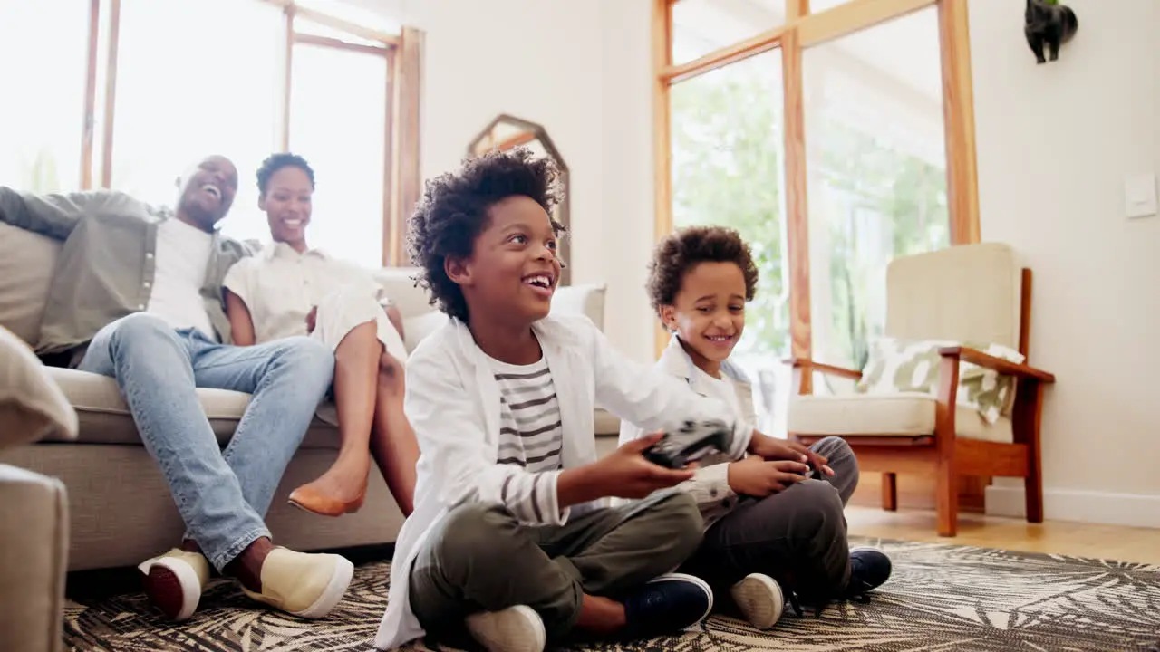 Happy black family and boys playing video games