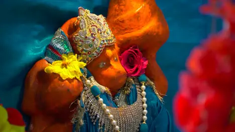 Close Up Of Statue Of Hindu God Hanuman Ji Covered In Sindoor Powder At Havan For Ceremony For Navratri