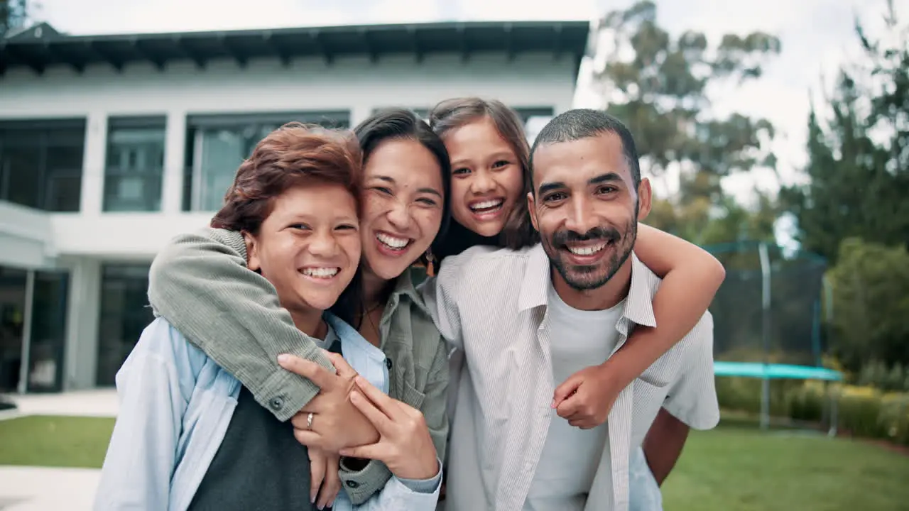 Happy family hug and new home on lawn in real