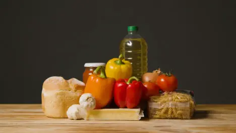 Studio Shot Of Basic Food Items On Wooden Surface And White Background 3