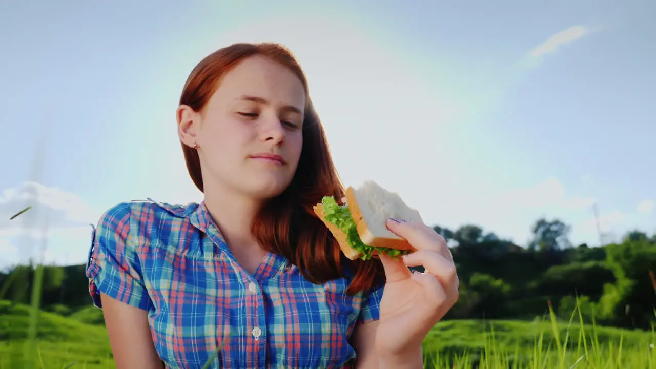 Portrait Of A Teenage Girl Eating A Sandwich