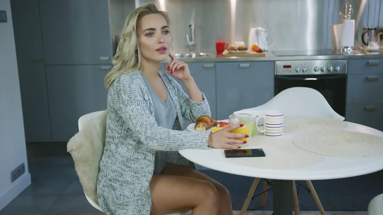 Smiling woman enjoying breakfast