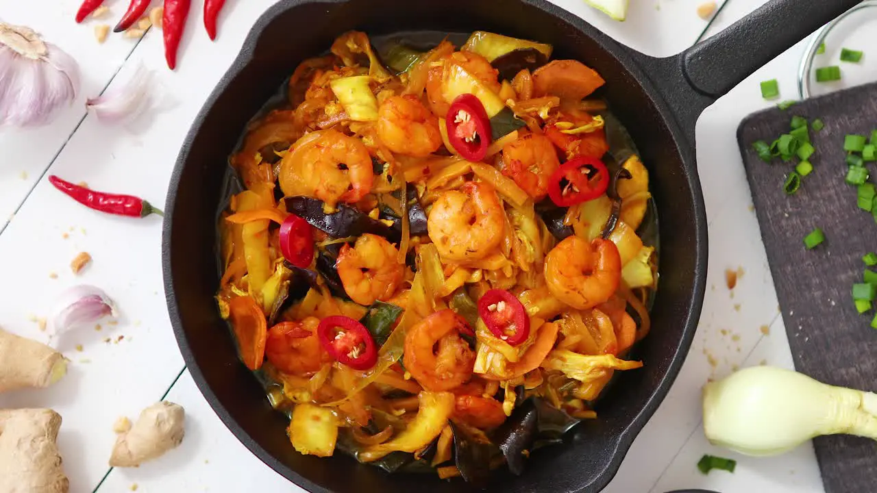 Fresh fried noodles with vegetables with shrimps served in black iron pan With various ingredients