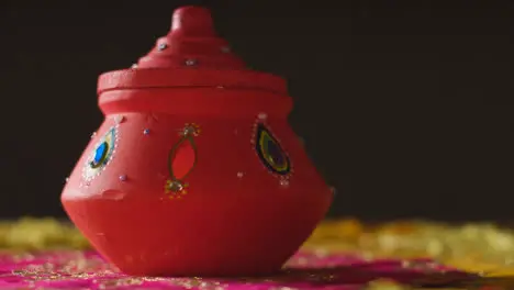 Traditional Clay Pot With Tea Lights On Table Decorated For Celebrating Festival Of Diwali 1