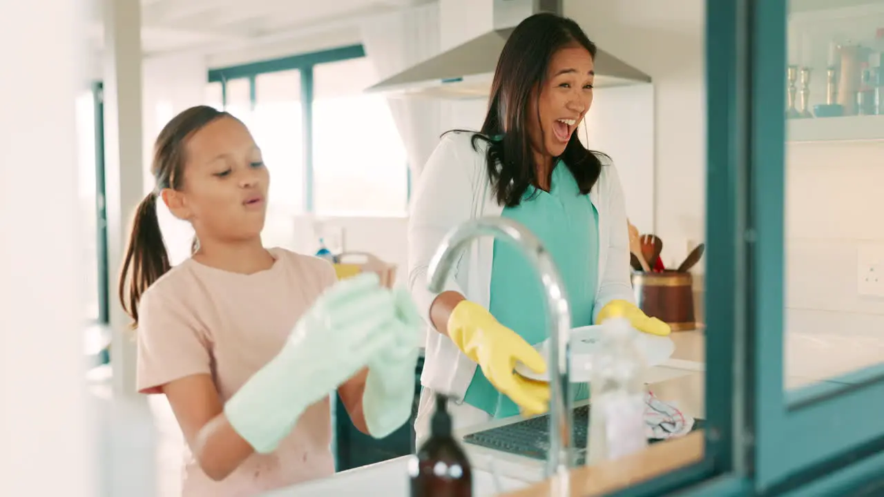 Mom girl and washing dishes in kitchen