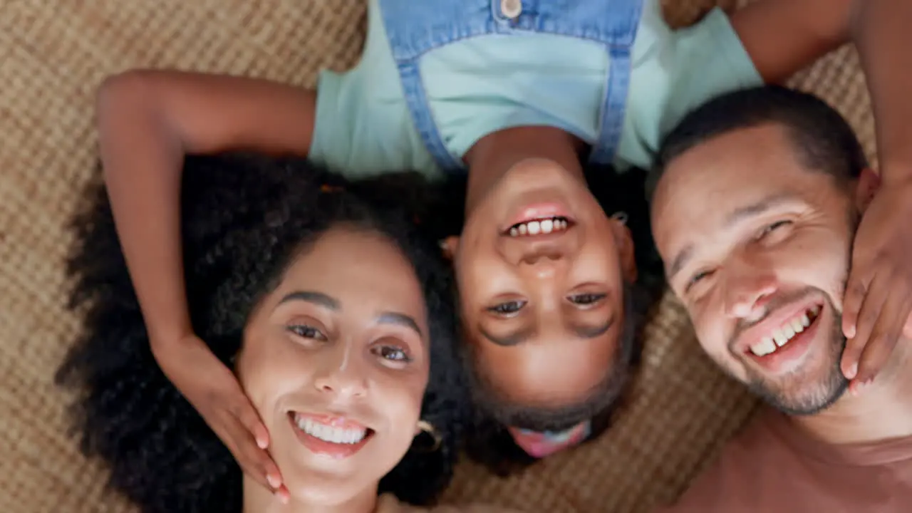 Happy family relax and hands on face on a floor