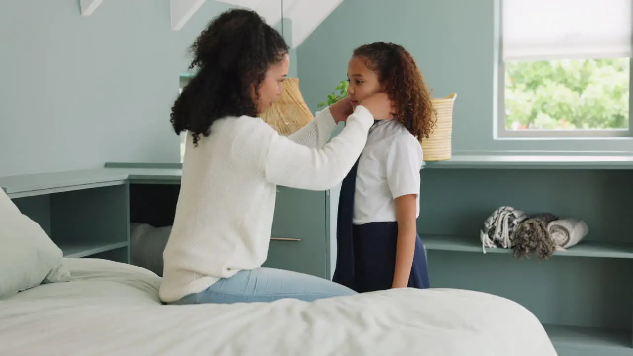 Mother girl and tie dressing for school