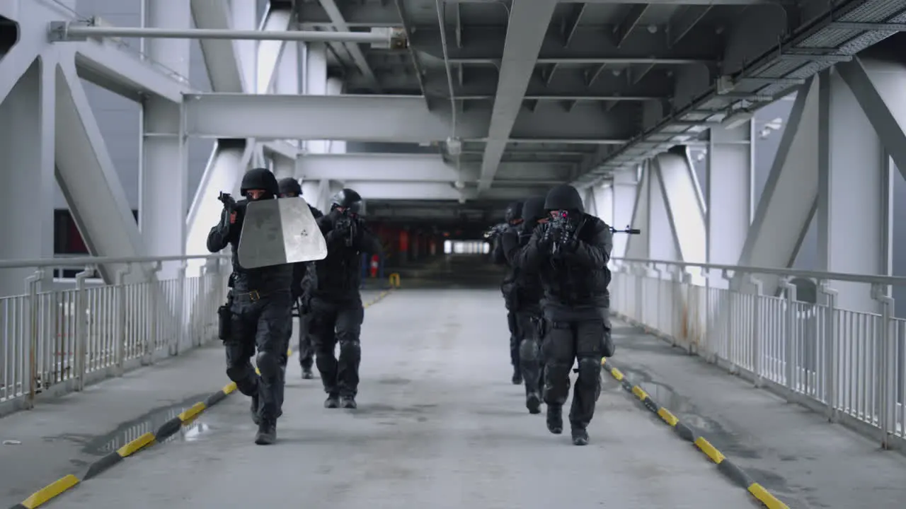 SWAT team walking on bridge Masked military soldiers using rifles