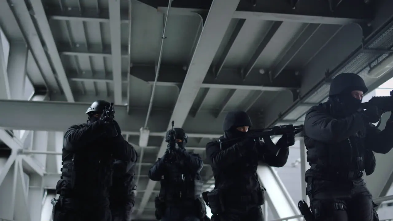 Police special forces protecting building SWAT officers in masks using rifles