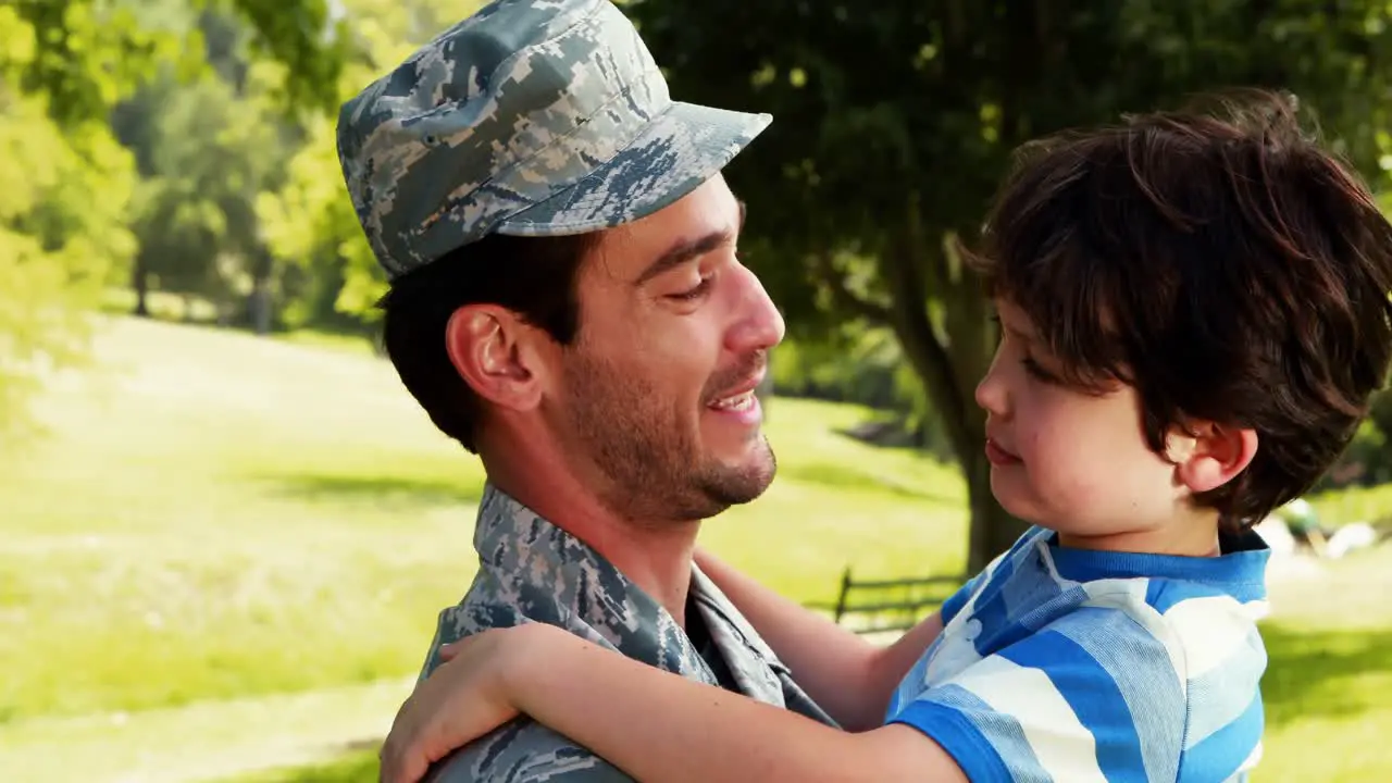 Army soldier interacting with his son in park