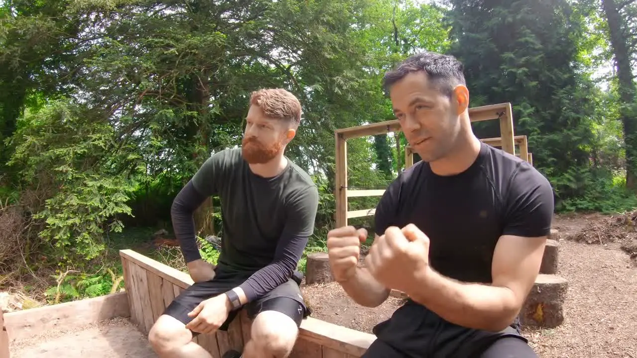 Fit men relaxing over obstacle course 4k