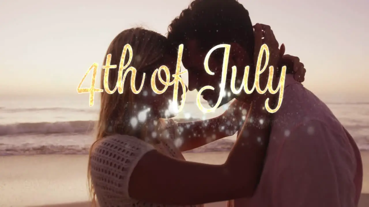 Independence day text and spots of light against caucasian couple embracing each other at the beach