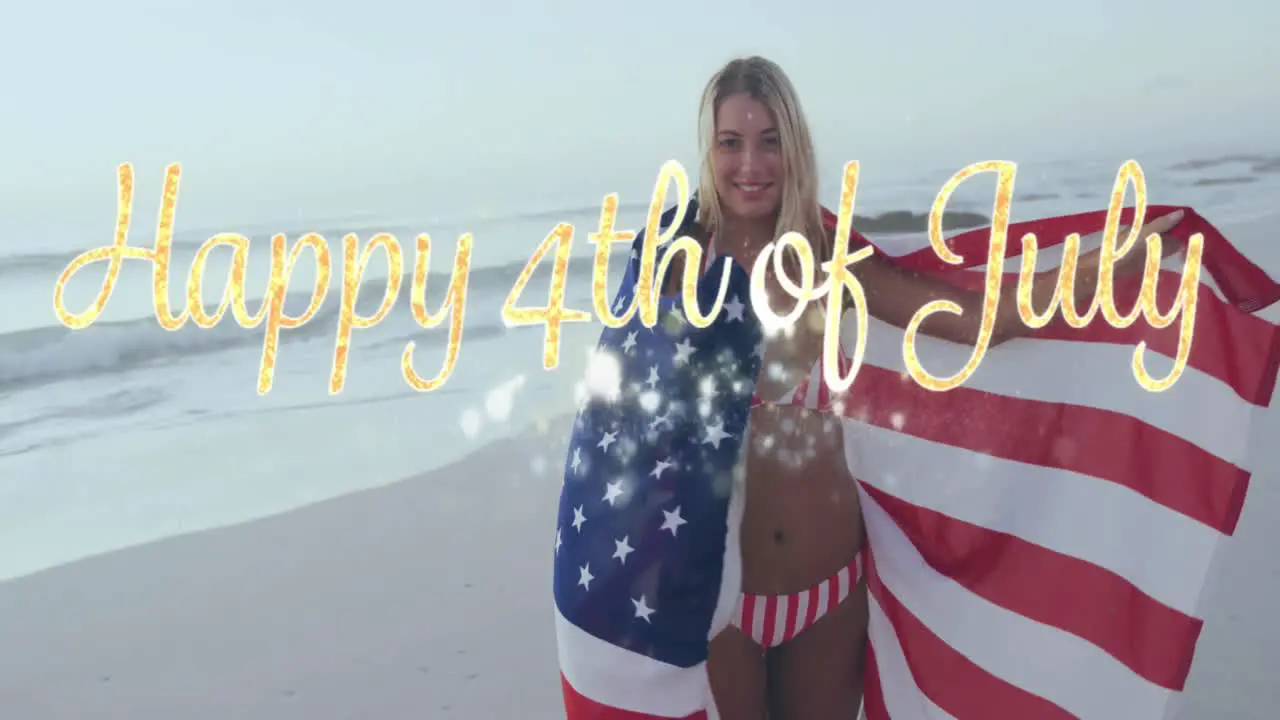 Happy 4th of july text against caucasian woman wrapping american around her on the beach