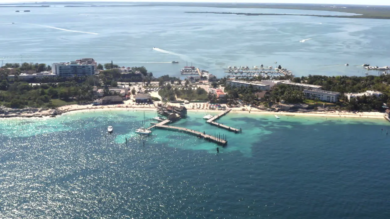 Sea piers on sandy tropical beach with holiday resort in Cancún