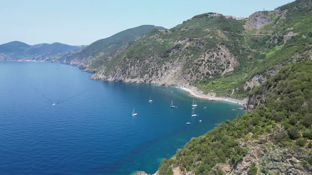 Boats and Scenic Coastline of Cinque Terre and Ligurian Sea in Italy Aerial 4k