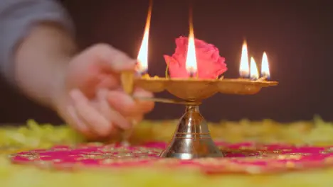 Hand With Five Wick Lamp With Decorations Celebrating Festival Of Diwali