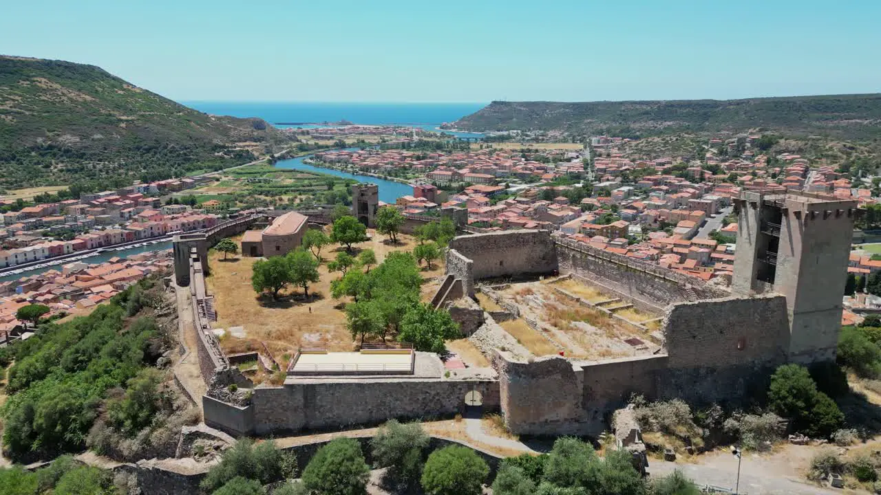 Serravalle castle overlooking Bosa Town in Sardinia Italy 4k Aerial