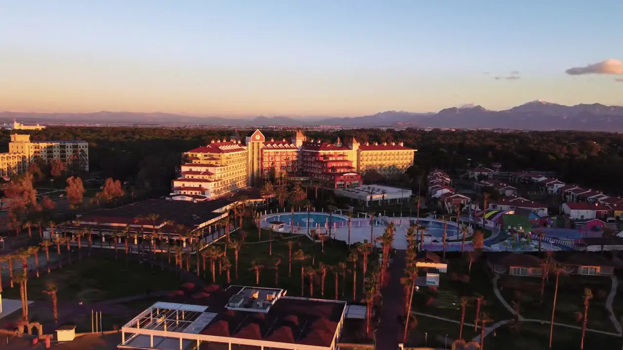 luxury holiday resort with pool and palms sunrise drone shot