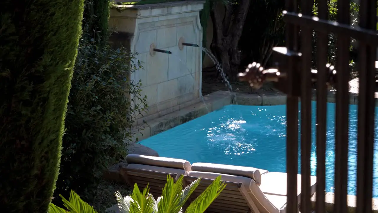 Beautiful outdoor pool with fountain in a garden of a luxurious castle in southern France