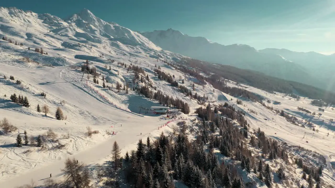 Beautiful ski resort slopes on snowy mountainside sunny aerial view