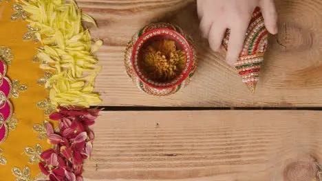 Overhead Of Traditional Coconut Pots On Table Decorated For Celebrating Festival Of Diwali 1