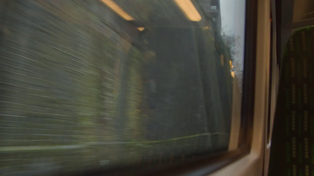 Looking out from moving train exiting tunnel