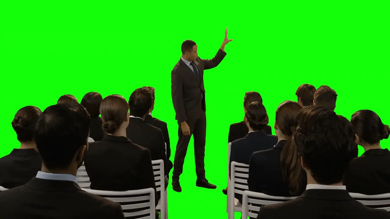 Businessman using futuristic digital screen while giving presentation to colleagues