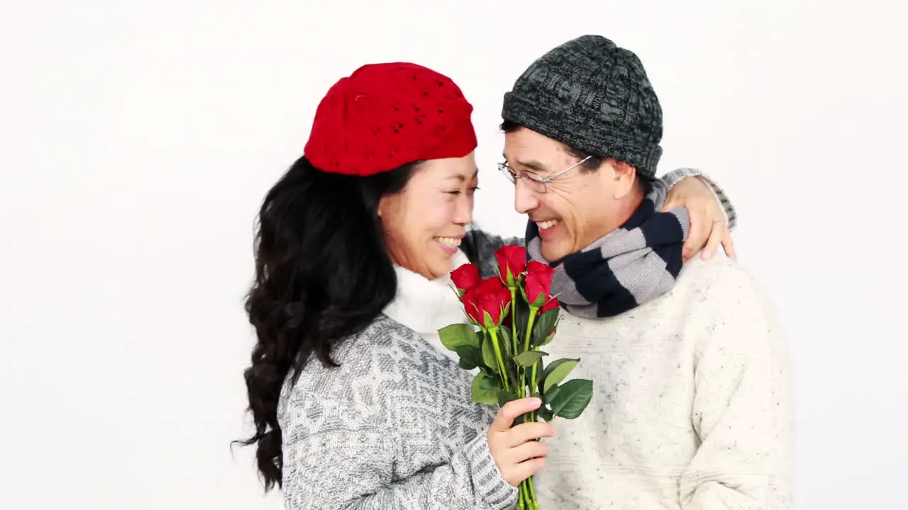 Asian man giving roses to his wife