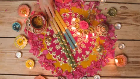 Overhead Shot Of Person Preparing Decorative Scene To Celebrate Festival Of Diwali