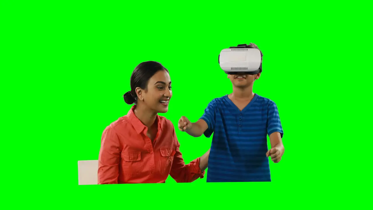 Smiling mother assisting son in using virtual reality headset 4k