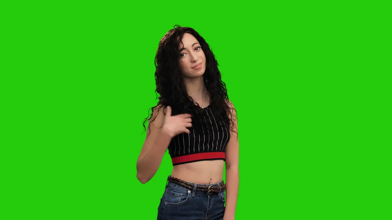 Caucasian girl with long curly hair wearing crop top turns around