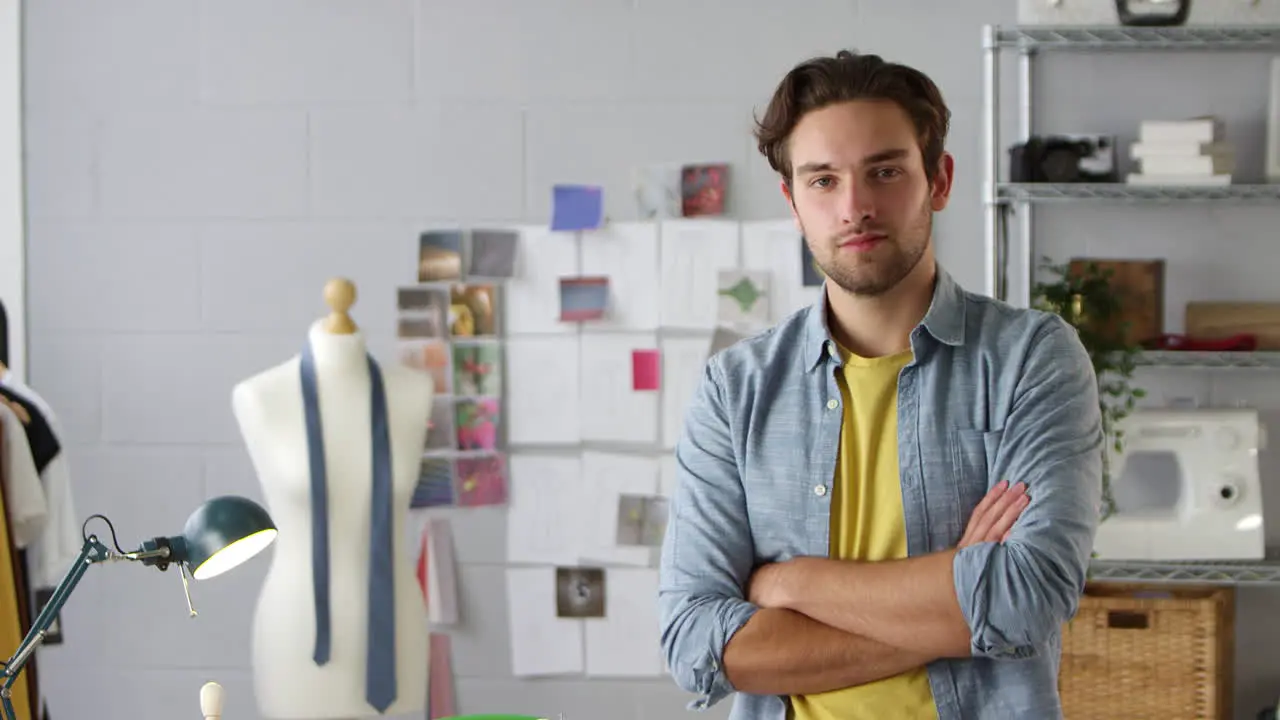 Portrait Of Determined Male Student Or Business Owner Working In Fashion By Desk