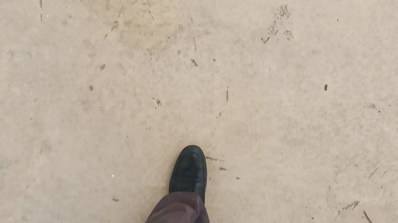 Businessman dressed in suitable attire walking to work on the concrete ground