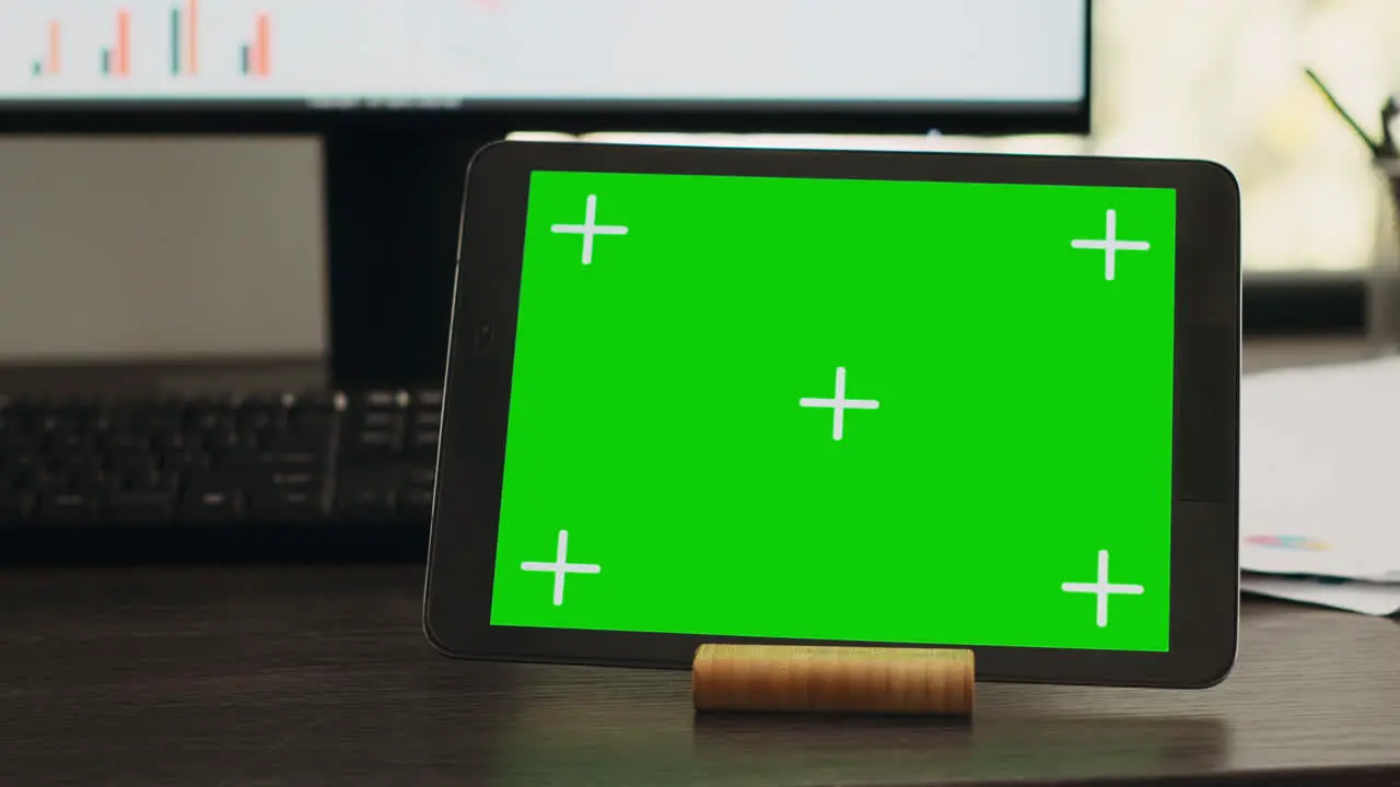 Empty desk with greenscreen on tablet