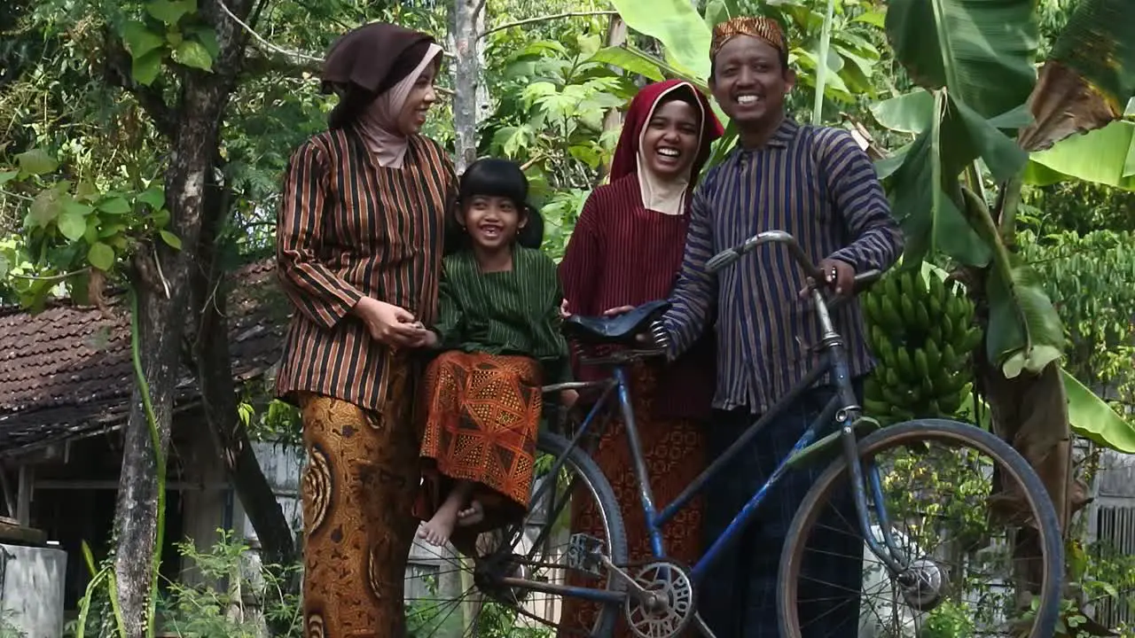 Javanese family with their two children on an ancient bicycle Central Java Indonesia