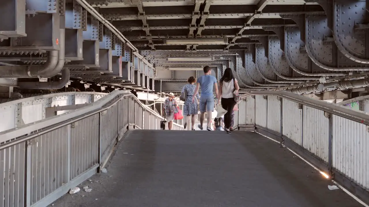 People Walking Under Bridge in Berlin