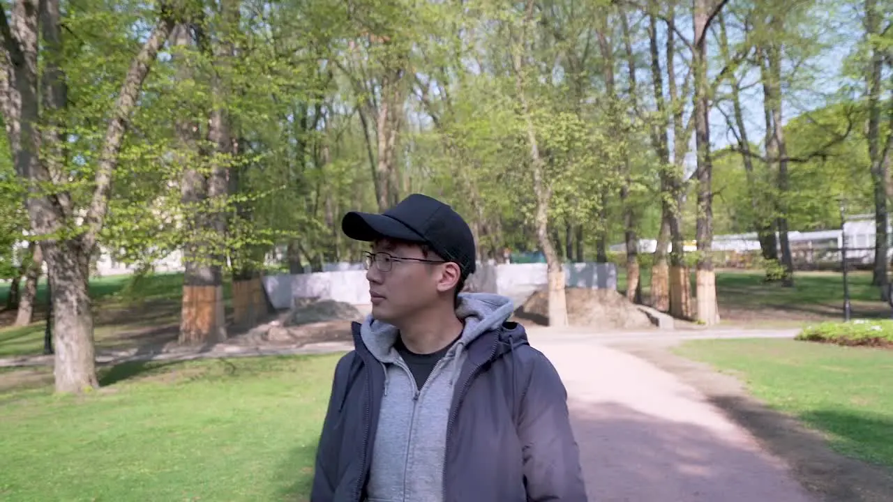 Gimbal shot of Tourist looking at the sights of the park at the Royal Palace of Oslo Norway