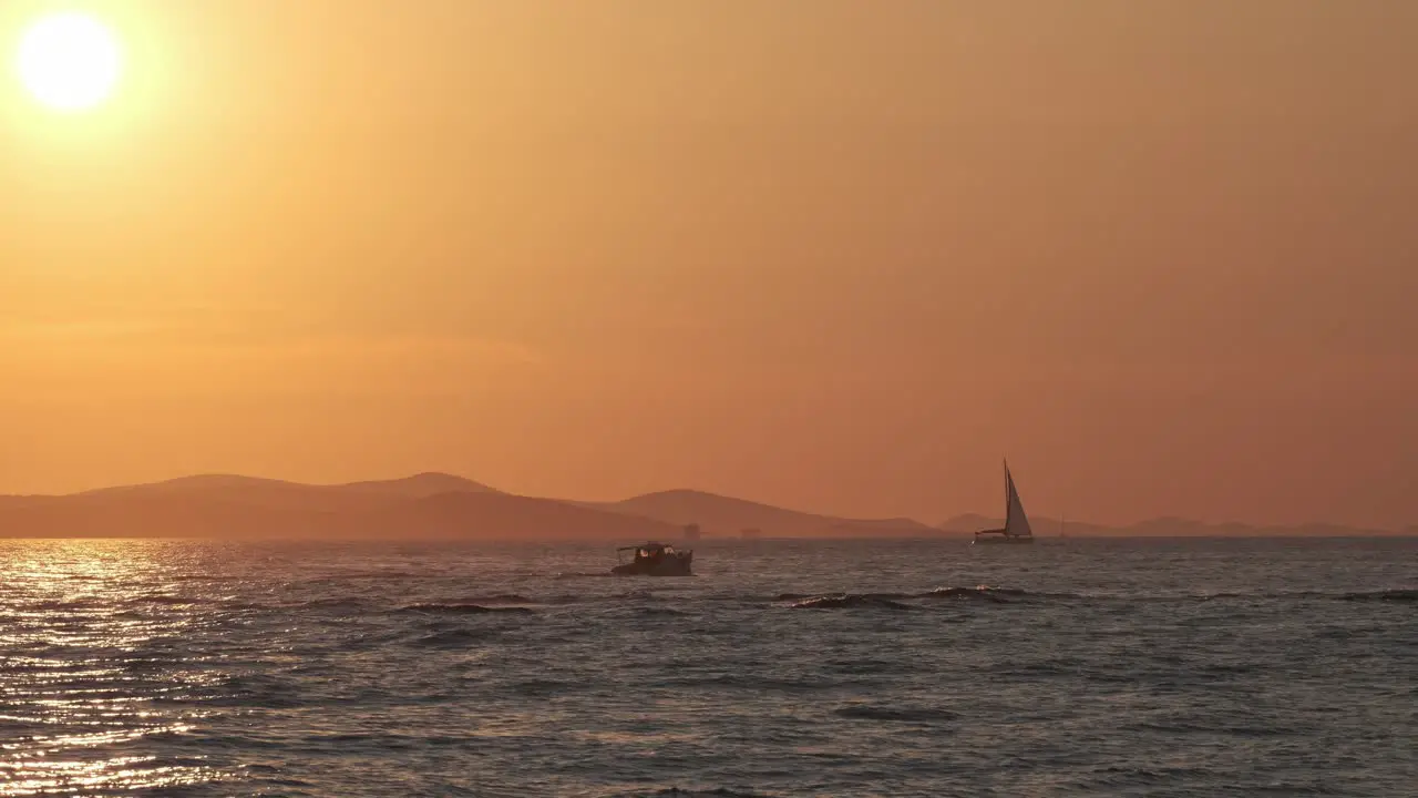 Sunset at Zadar Riva Croatia with boats sail boats and people walking