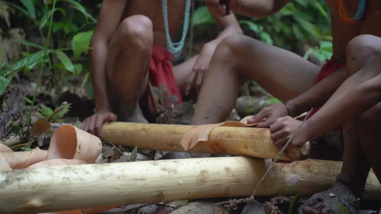 Members of the Mentawai Tribe in Indonesia make the material they use to create their loincloths