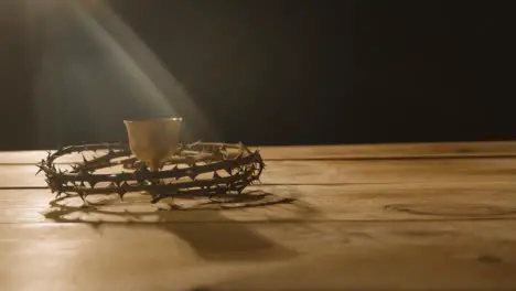 Religious Concept Shot Of Chalice With Crown Of Thorns Placed Around It On Wooden Background 