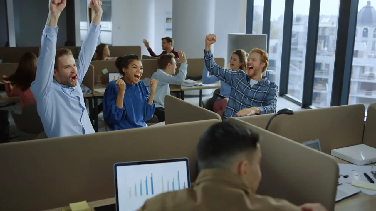 Business team celebrating success in office Colleagues giving high five