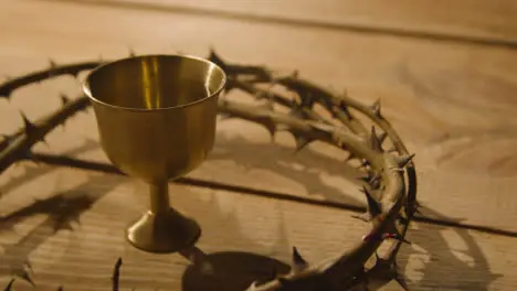 Religious Concept Shot Of Chalice With Crown Of Thorns Placed Around It On Wooden Background 2