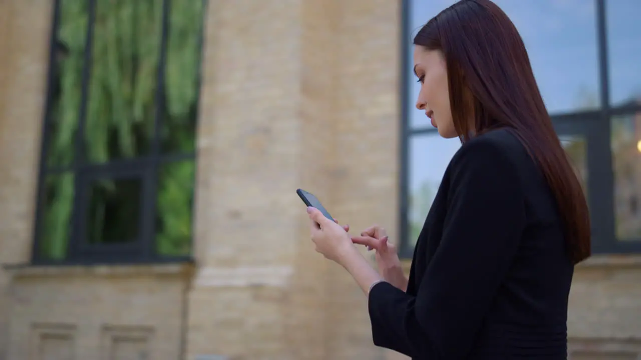 Businesswoman scrolling mobile phone outdoor People walking street with devices