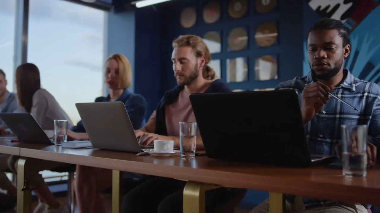 Multiethnic business people working laptop computers at workplace in coworking